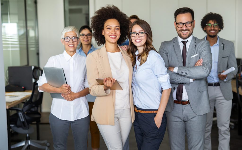 Professional team in formal attire in an office, illustrating professional liability and business insurance in Quebec.