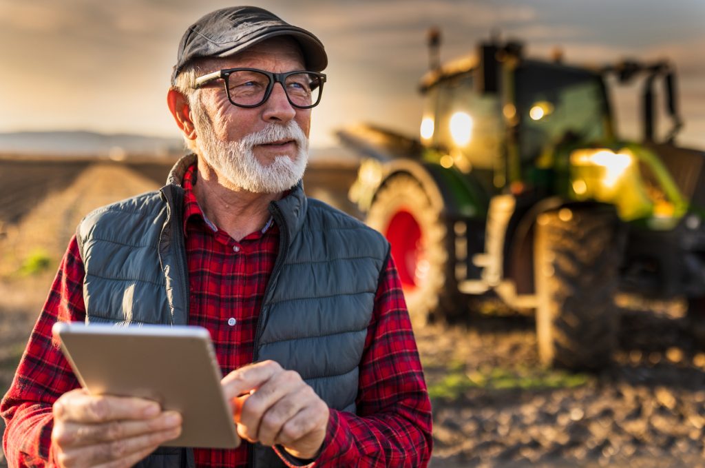 Farmer reviewing farm information to plan the next growing season after harvest.